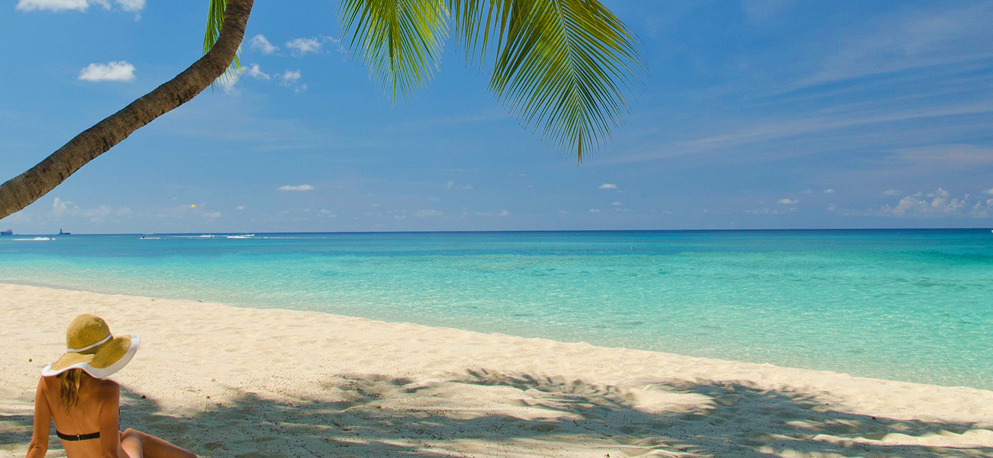 Woman Relaxing On A Beach In The Cayman Islands